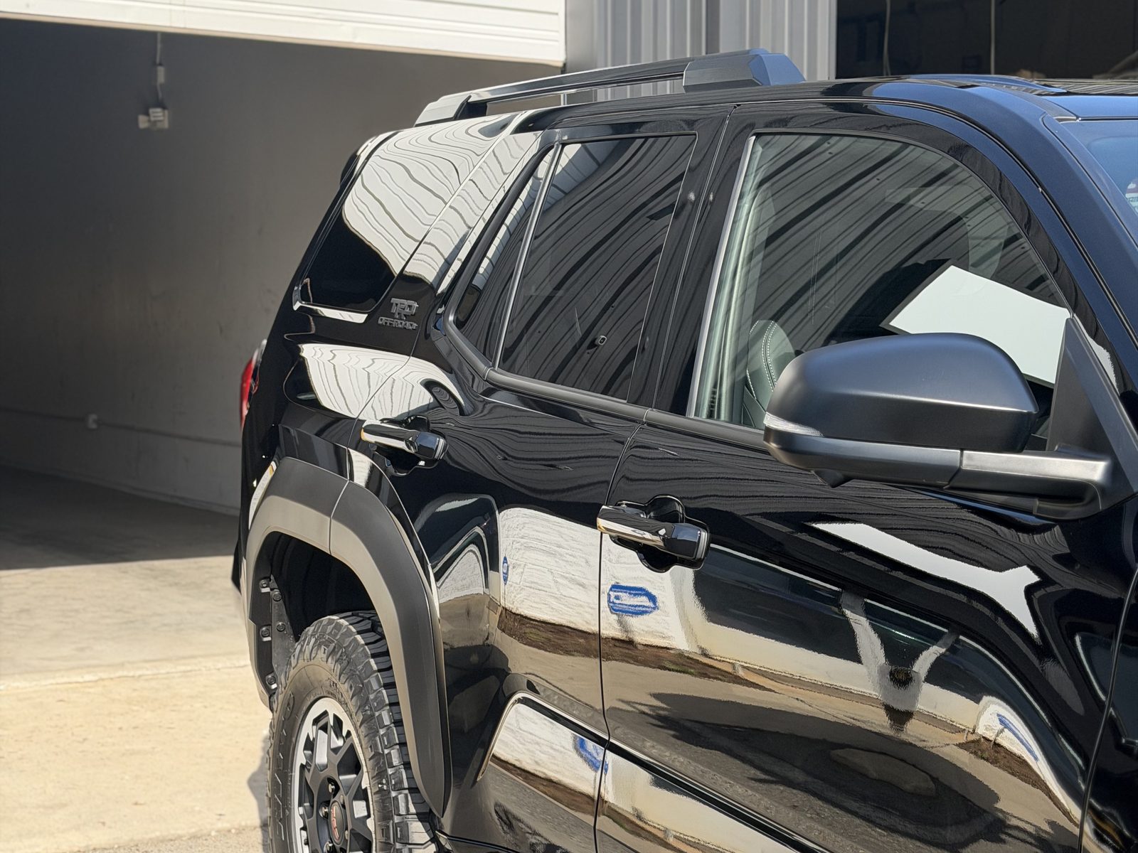 Black SUV with dark ceramic window tint, side profile, Charlotte NC