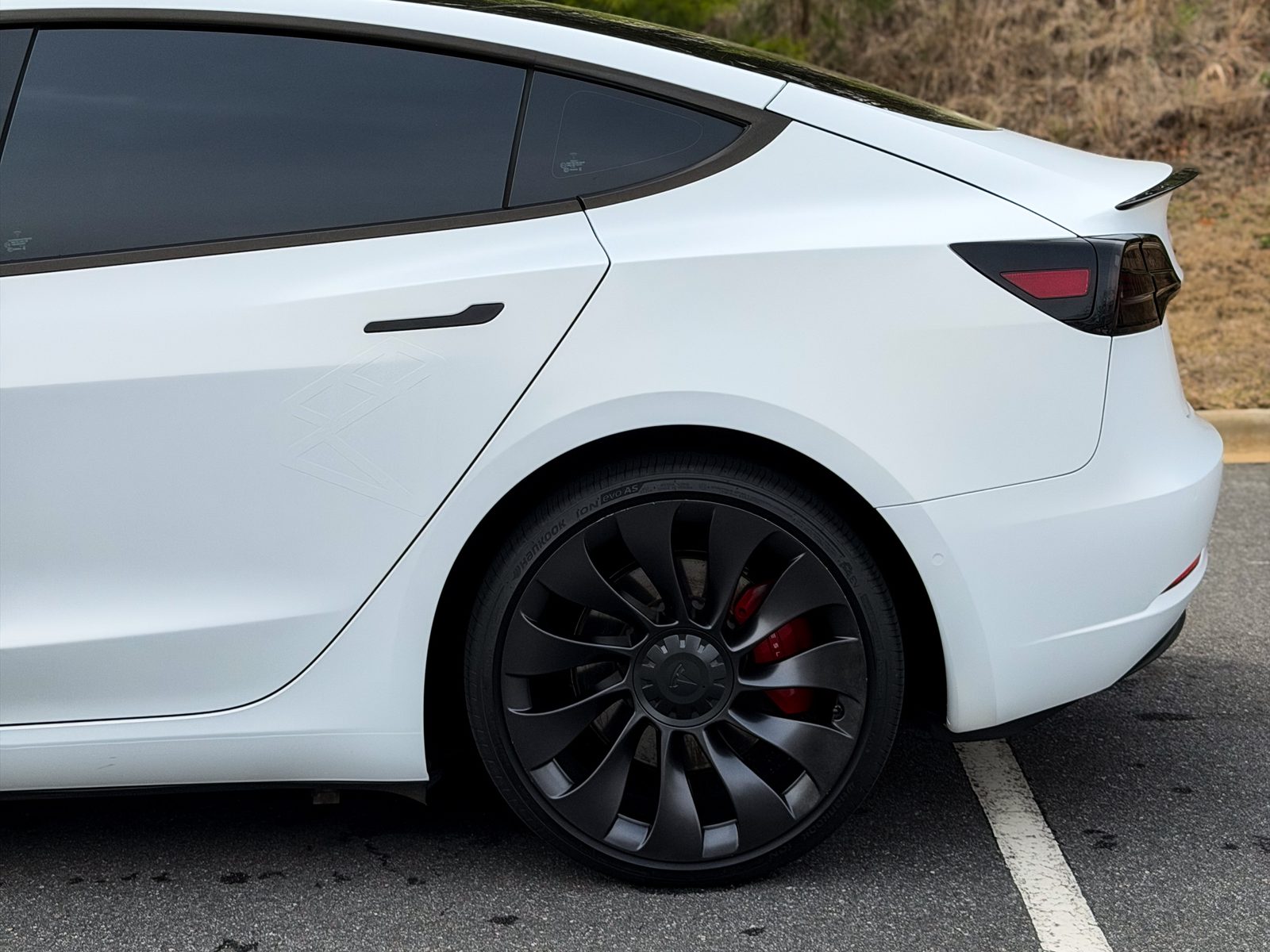 White Tesla with dark tinted windows, side profile, Charlotte NC