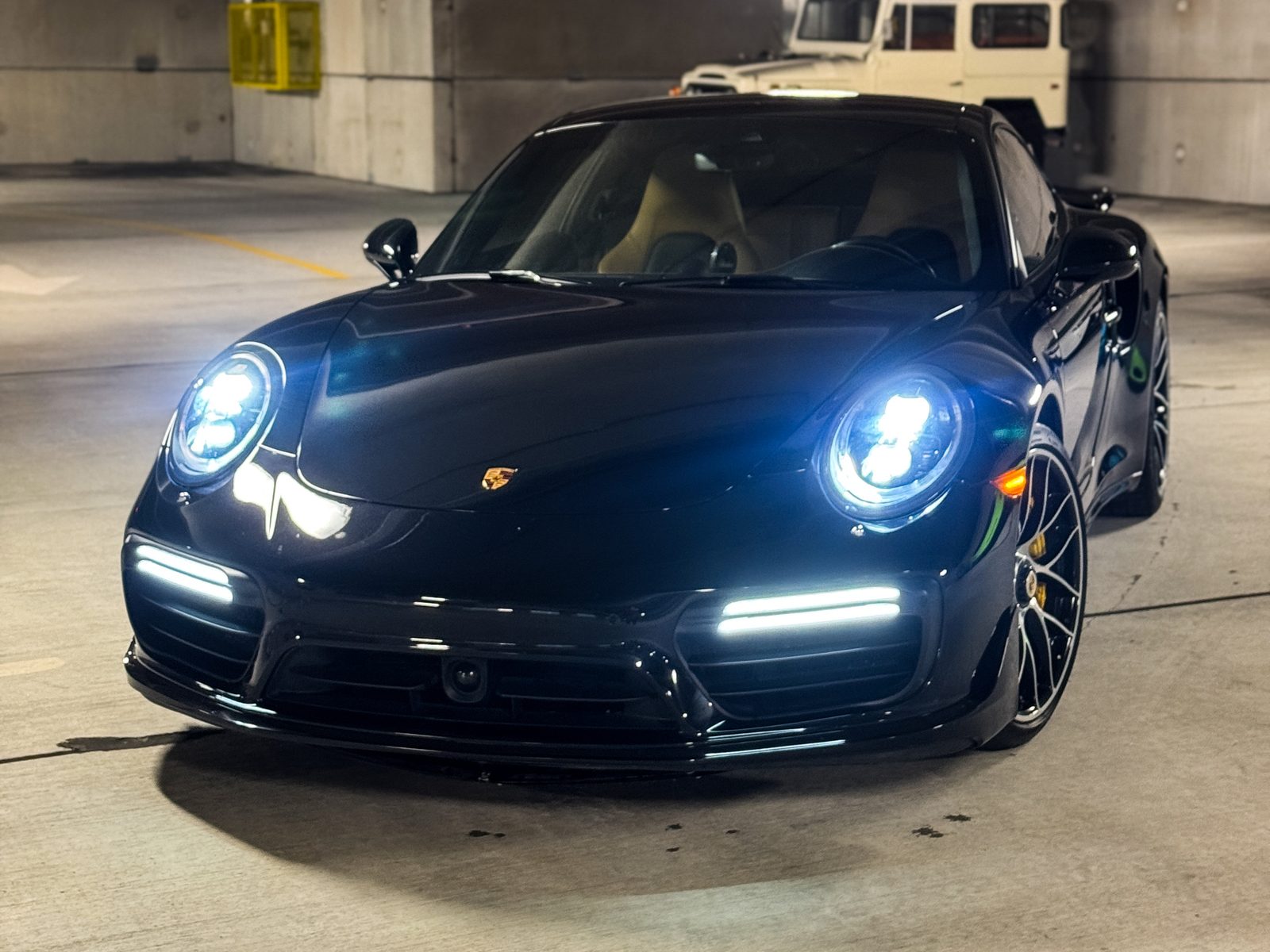 Black Porsche coupe with headlights on, Red Wagon Detailing Charlotte NC