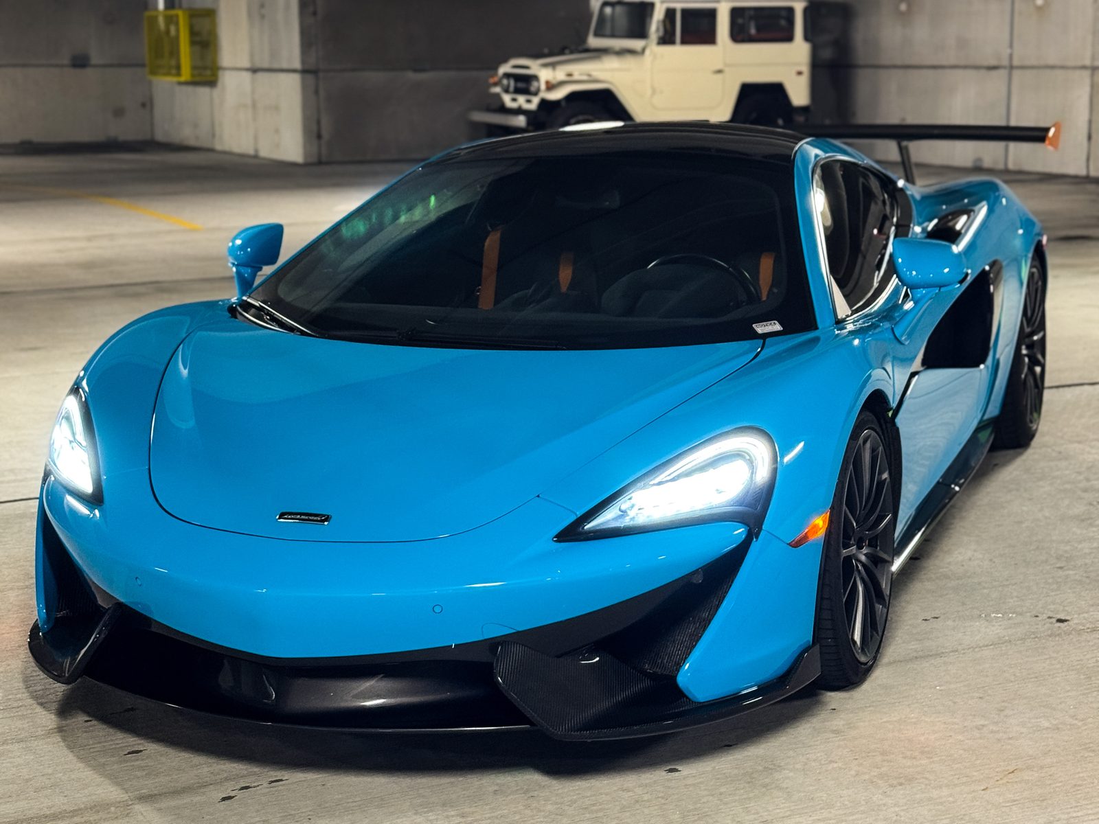 Blue McLaren sports car in a parking garage, Red Wagon Detailing Charlotte NC